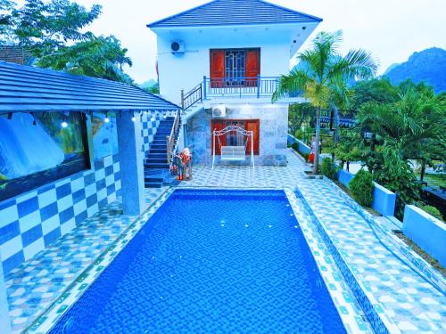 a house with a swimming pool in front of a house at The Ridge Haven in Phong Nha