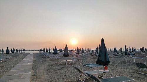 a bunch of chairs and umbrellas on a beach at Residence Rimini Relax in Rimini