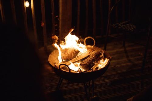 a fire pit in a room with flames in it at Cottage Orné in Long Bredy
