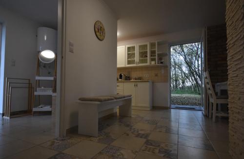 eine Küche mit einer Bank in der Mitte eines Zimmers in der Unterkunft Varázslakos Tanya in Soltvadkert