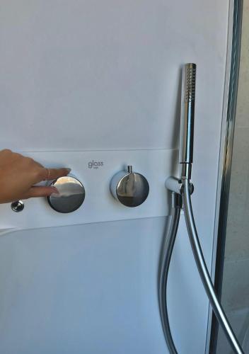 a person holding a knob on a stove at Il Piccolo Giardino GH ***Superior in Taormina