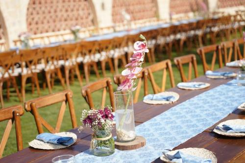 a long table with flowers on it with chairs at Zad El Mosafer Guest House in Tunis