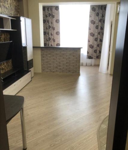 een woonkamer met een open haard en een houten vloer bij VIP apart 492 in Tbilisi City