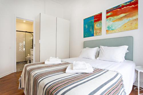 a bedroom with a bed with two towels on it at Alagoa Apartments in Tavira