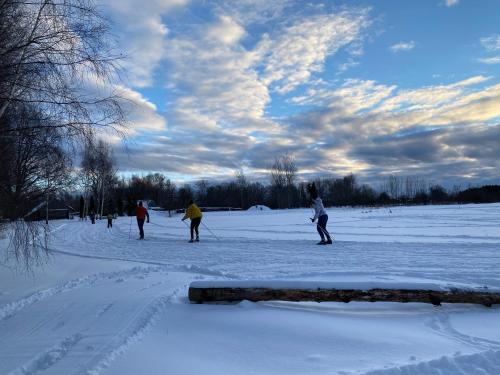 a group of people skiing in the snow at Duseli Holiday House Tutti in Klīvji
