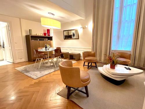 un salon avec une table et des chaises dans l'établissement L'appartement Pierre Charron, à Paris