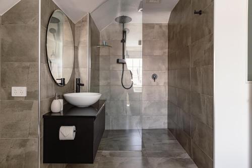 a bathroom with a sink and a mirror at Sanctum Boutique Apartments in Hobart