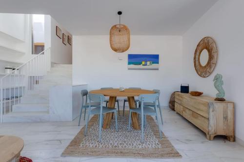 a dining room with a wooden table and chairs at CASA LIMA - State of the art villa with views and pool in Ferragudo in Ferragudo