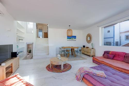 a living room with a couch and a table at CASA LIMA - State of the art villa with views and pool in Ferragudo in Ferragudo