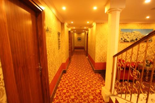 a hallway of a building with a staircase and a hallwayngthngthngthngthngth at Tuğhan Hotel in Mardin