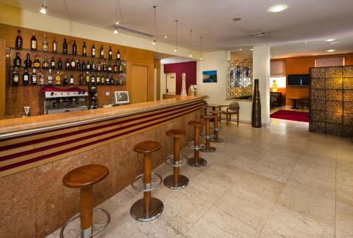 a bar with a lot of tables and chairs at Luna Esperanca Centro Hotel in Setúbal