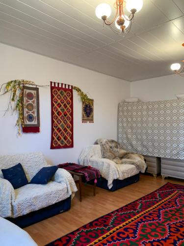 a living room with two beds and a couch at BAYRAKzone in Tar-Suu