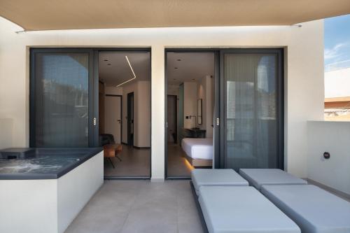 a room with sliding glass doors and a bedroom at Nema Hotel Athens in Athens