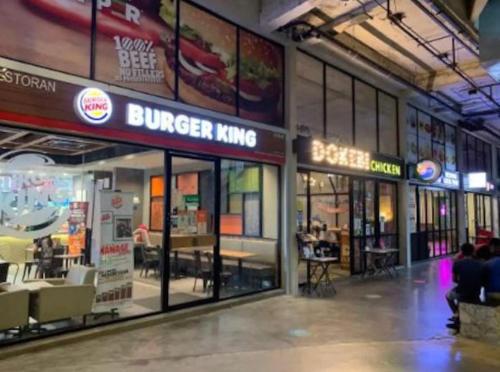 a burger king store in a building with people inside at Tamarind suite 2Q beds Cyberjaya in Cyberjaya