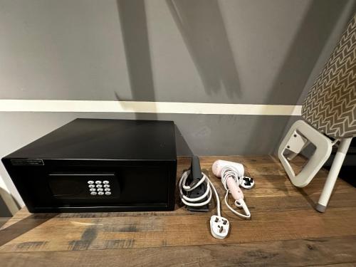 a microwave sitting on top of a wooden floor at Tamarind suite 2Q beds Cyberjaya in Cyberjaya