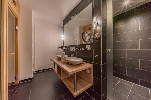 a bathroom with a sink and a mirror at Resort Deichgraf Resort Deichgraf 31-07 in Wremen