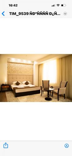 a bedroom with a bed and a table and chairs at Hotel Zhibek Zholy in Shymkent