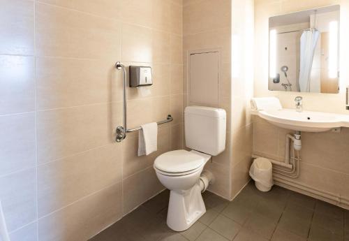 a bathroom with a toilet and a sink at B&B HOTEL Rennes Nord St Grégoire in Saint-Grégoire