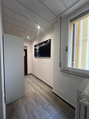 a hallway with a window and a painting on the wall at Hotel Villa Itala in Rimini