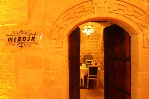 an archway leading to a dining room with a table at Tuğhan Hotel in Mardin