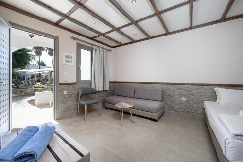 a living room with a couch and a table at Palladium hotel in Marmari