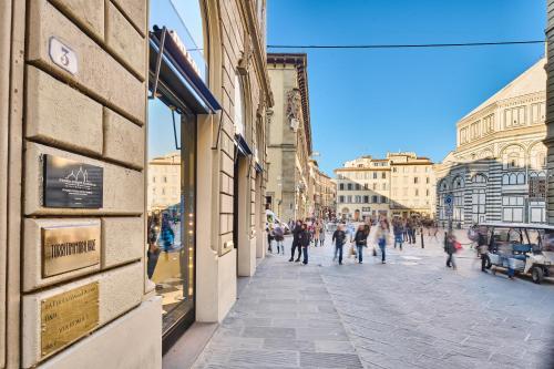 a group of people walking down a street at Duomo Luxury Florence in Florence