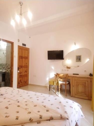 a bedroom with a bed and a table and a desk at Park Hotel Amfora -Free Parking in Sofia