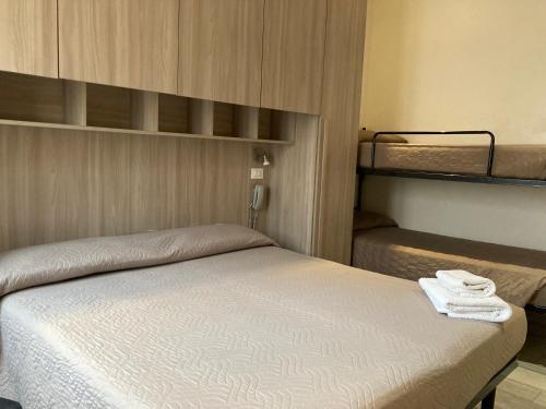 a bedroom with a bed and a bunk room at Hotel Villa Itala in Rimini