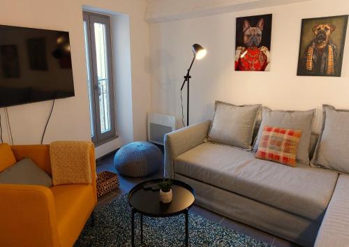 a living room with a couch and a table at LA MAISON BARNOIN - gîtes et chambres in Bouyon