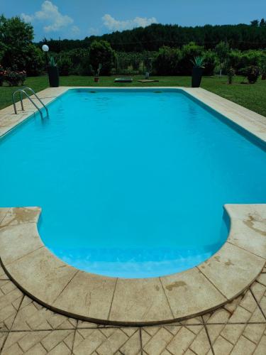 a large swimming pool with blue water at Tenuta Quadrone in Cura