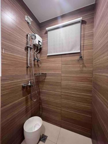 a bathroom with a toilet and a projection screen at Studio unit in Prime Location in Davao City