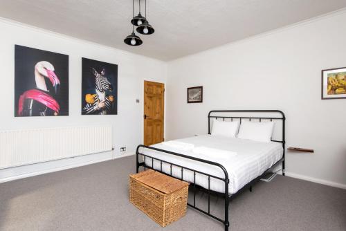 a bedroom with a bed and some pictures on the wall at River-Twine in Croxdale