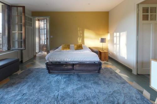 a bedroom with a bed and a blue rug at Le Petit Eloi in Saint-Gervais-les-Bains