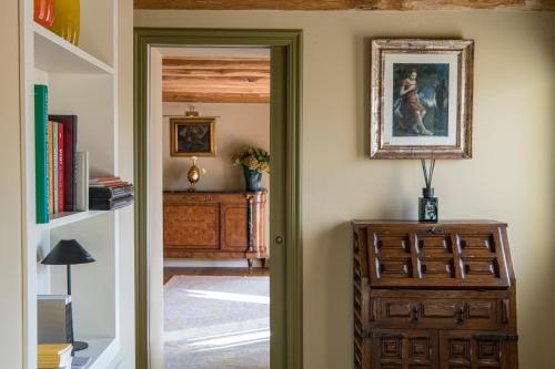 a door to a room with a dresser and a picture at Casa Valdo Country House in Valdobbiadene