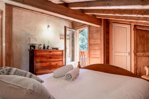 a bedroom with a large white bed and a window at Les Cristalliers - Cozy family chalet - Close to the village in Les Houches