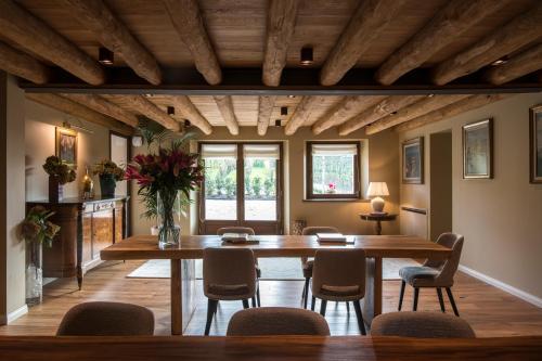 a dining room with a large wooden table and chairs at Casa Valdo Country House in Valdobbiadene