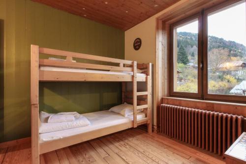 two bunk beds in a room with a window at Saint Éloi - Panoramic view - Mont Joly - Central in Saint-Gervais-les-Bains