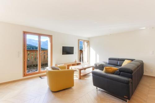 a living room with a couch and a chair at L'Abeille - Renovated - 4 bedroom - 8 person-110sqm - Views! in Les Houches