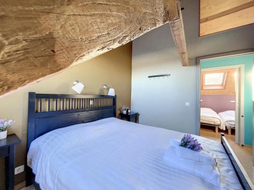 a bedroom with a large bed with a wooden headboard at Blauwhof - Steenkerke in Veurne