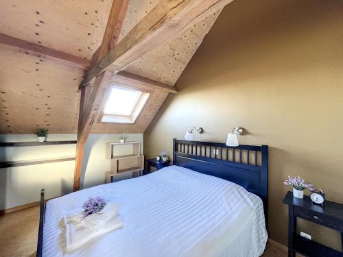 a bedroom with a large bed and a window at Blauwhof - Steenkerke in Veurne