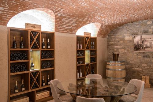a dining room with a table and a wine cellar at Casa Valdo Country House in Valdobbiadene