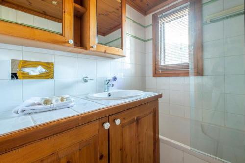 a bathroom with a sink and a mirror at Le Petit Paradis - Indoor pool and sauna in Chamonix-Mont-Blanc