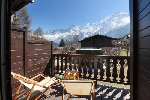 a balcony with a chair and a view of mountains at Chalet Charousse in Les Houches