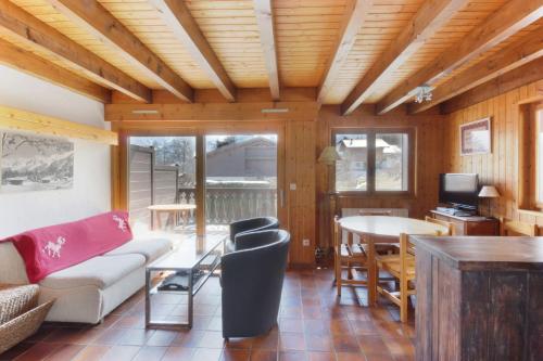 a living room with a couch and a table at Chalet Charousse in Les Houches
