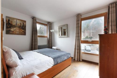 a bedroom with a bed and a window at L'Outa - Center of Chamonix - Mont-Blanc view in Chamonix