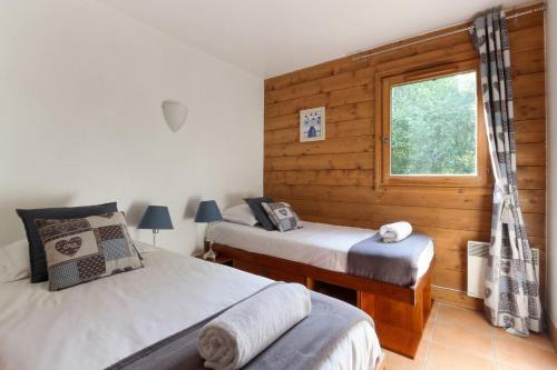 a bedroom with two beds and a window at Le Grand Tetras - Beside Lake Chavants, TMB staring point & Hikes in Les Houches