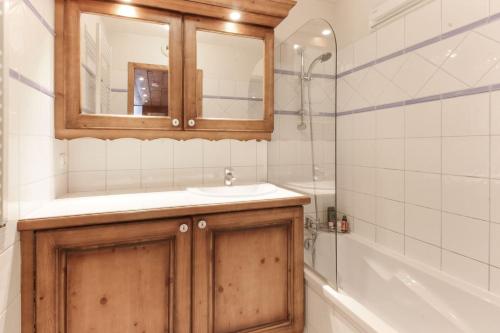 a bathroom with a sink and a mirror and a tub at Le Grand Tetras - Beside Lake Chavants, TMB staring point & Hikes in Les Chavants