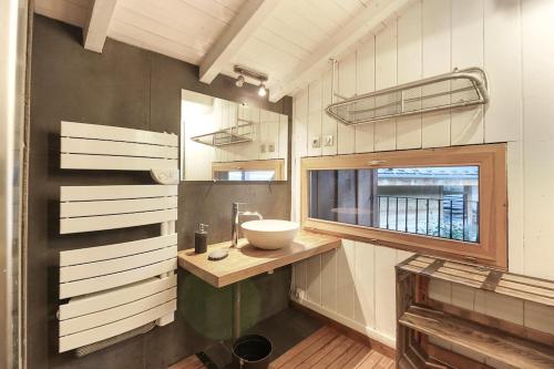 a bathroom with a sink and a window at Chalet of the 5 Chardons ski-in ski-out in Les Houches