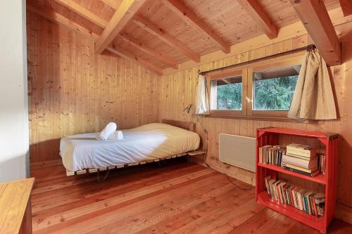 a bedroom with a bed in a wooden room at Chalet of the 5 Chardons ski-in ski-out in Les Houches