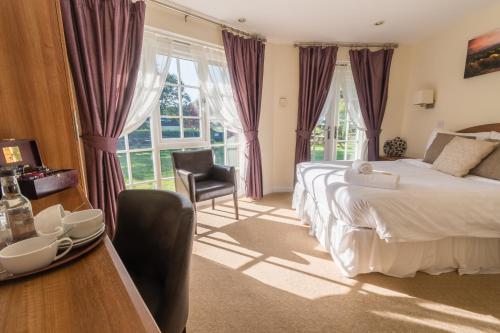 1 dormitorio con 1 cama y 1 mesa con silla en The Dewdrop Inn en Worcester